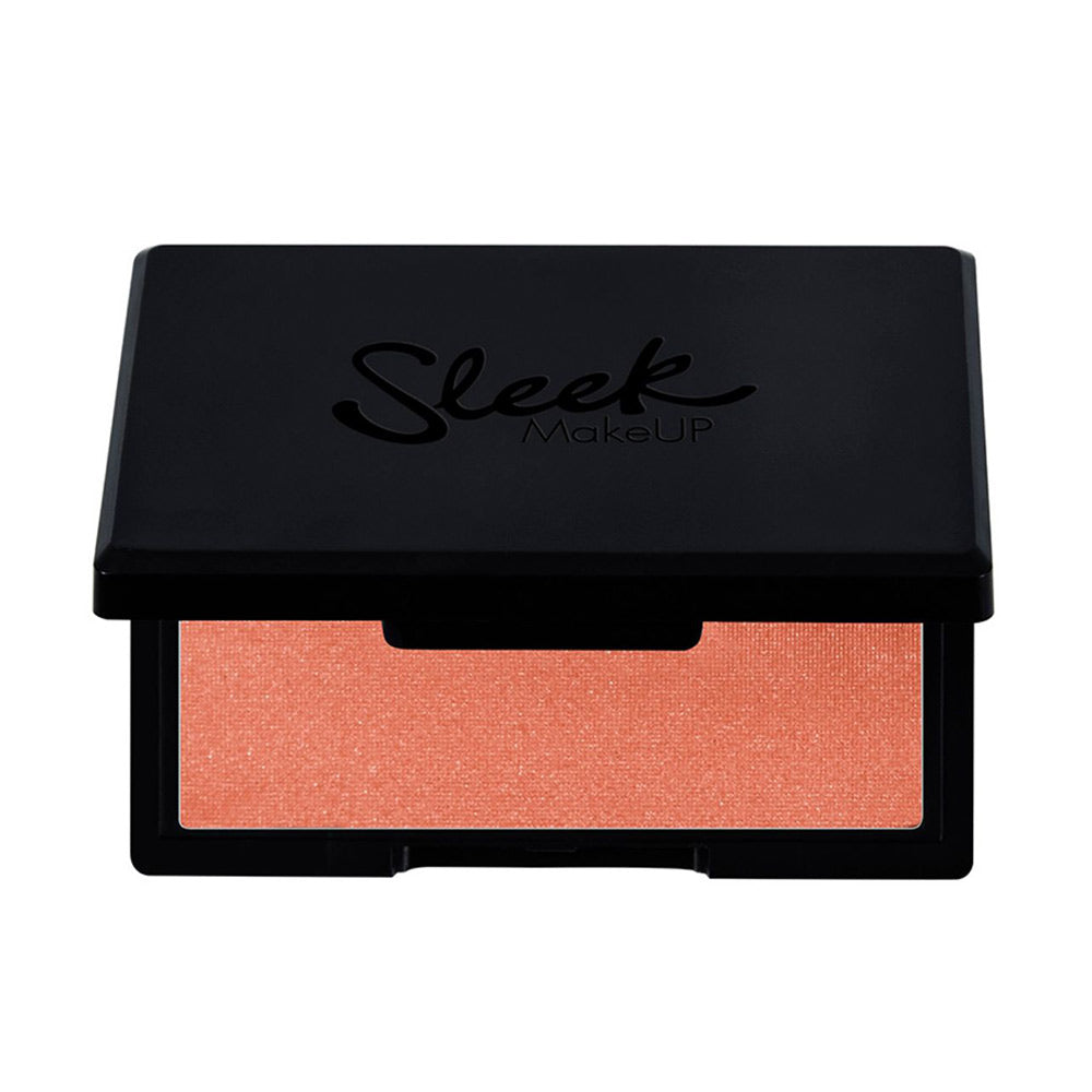 Round compact powder blush pan, warm coral shade, slim travel case