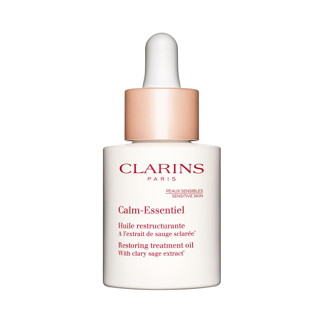 Glass 30 ml bottle of reparative facial oil with dropper, amber oil visible