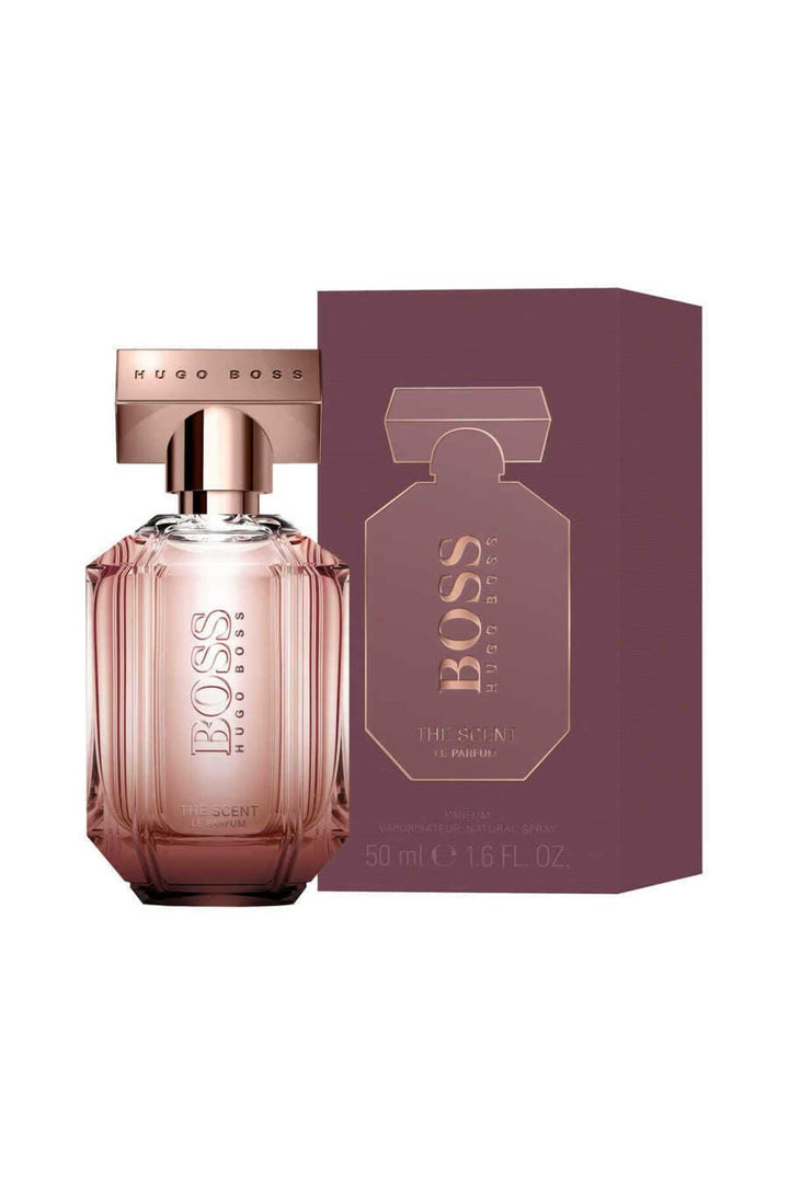 Glass perfume bottle with amber liquid, minimalist label, wooden cap