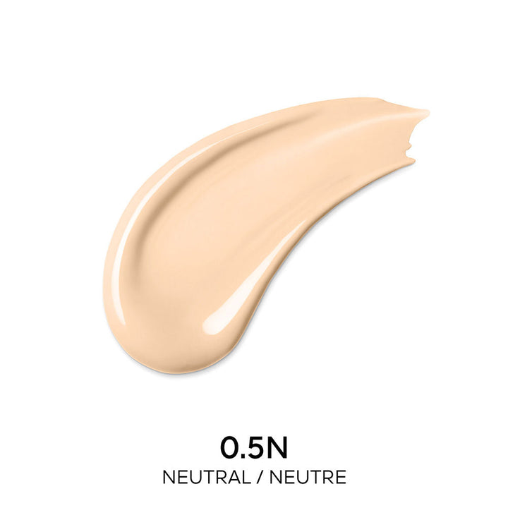 Guerlain Beige and dark brown liquid concealer in transparent cylindrical bottle with metallic cap and wand.