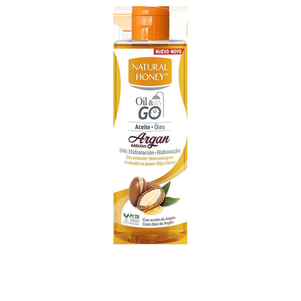 Natural Honey Transparent plastic bottle with warm orange-golden oil, flip-top cap, label showing argan nuts