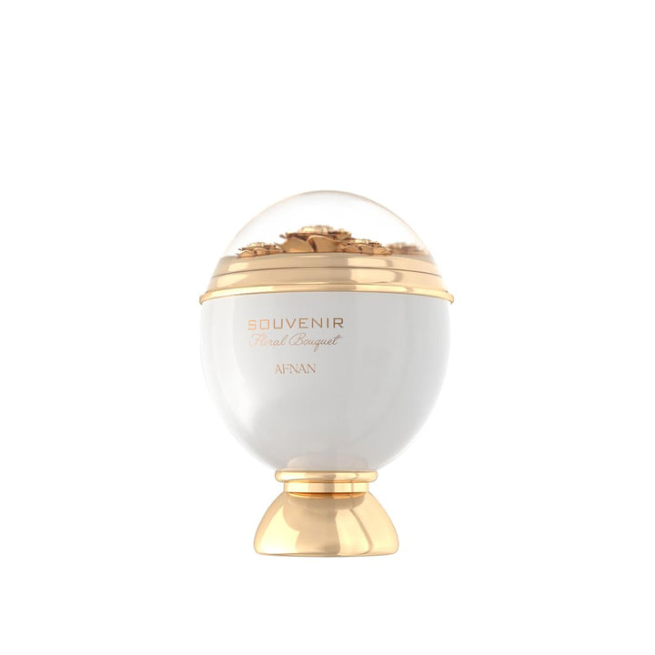 White dome perfume bottle with gold decorative base and floral detail under transparent top, Afnan.