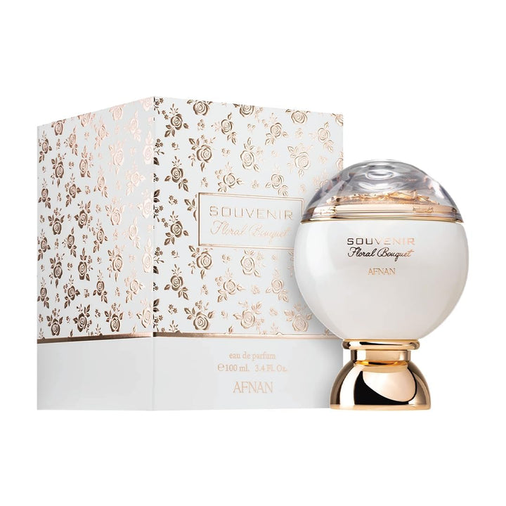 White dome perfume bottle with gold decorative base and floral detail under transparent top, Afnan.