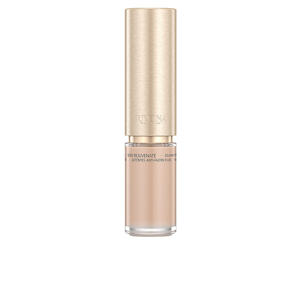 Beige and gold glass fluid bottle with transparent lower cylinder and metallic textured cap, Juvena