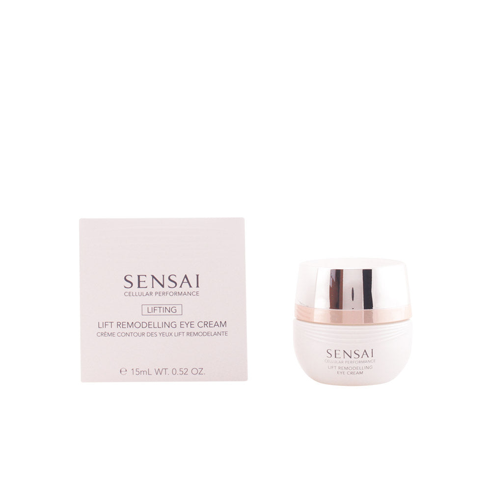 Sensai White plastic eye cream jar and silver massager beside minimalist cardboard box, refined craftsmanship visible