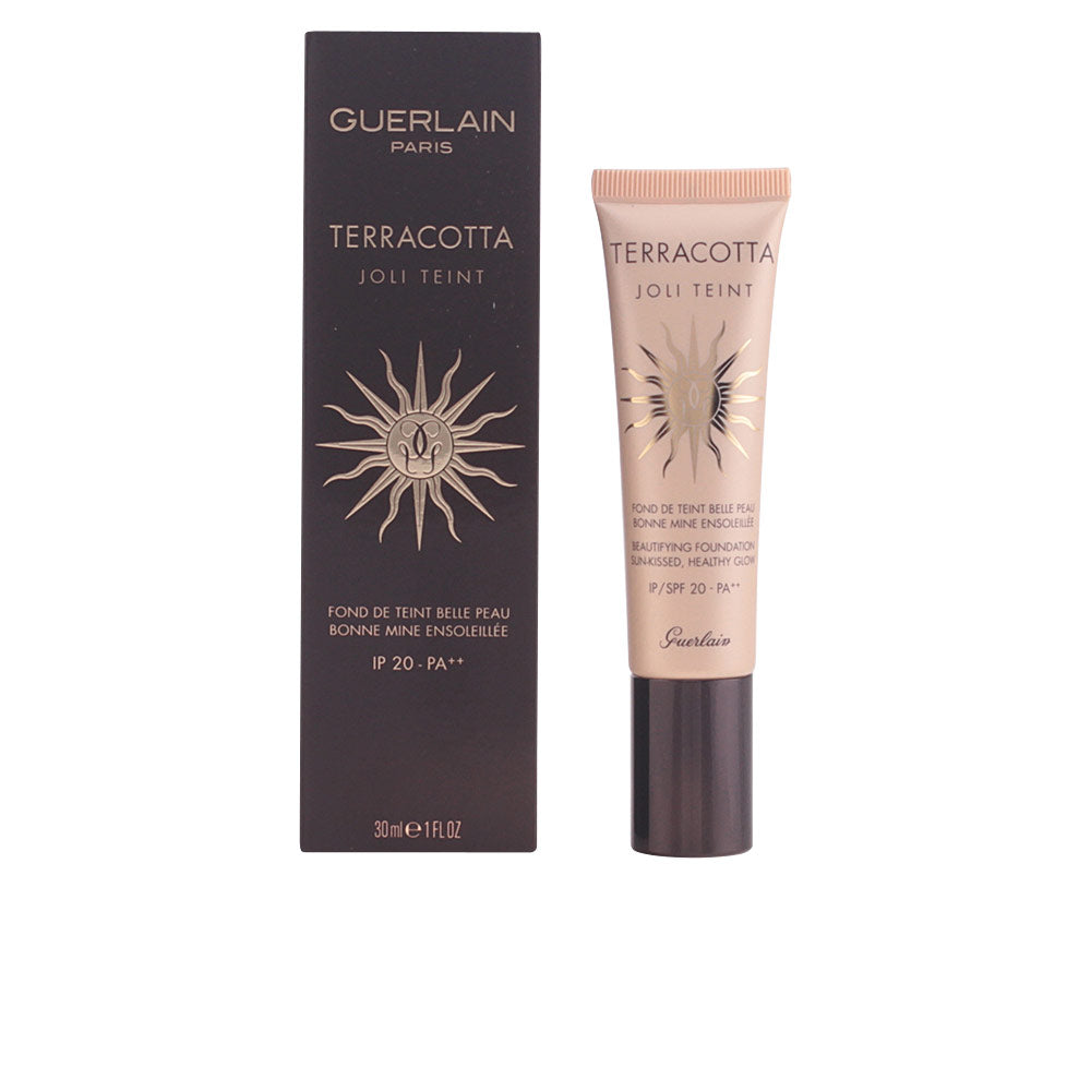 Black and beige tube with gold sun emblem, plastic tube and cardboard box, Guerlain