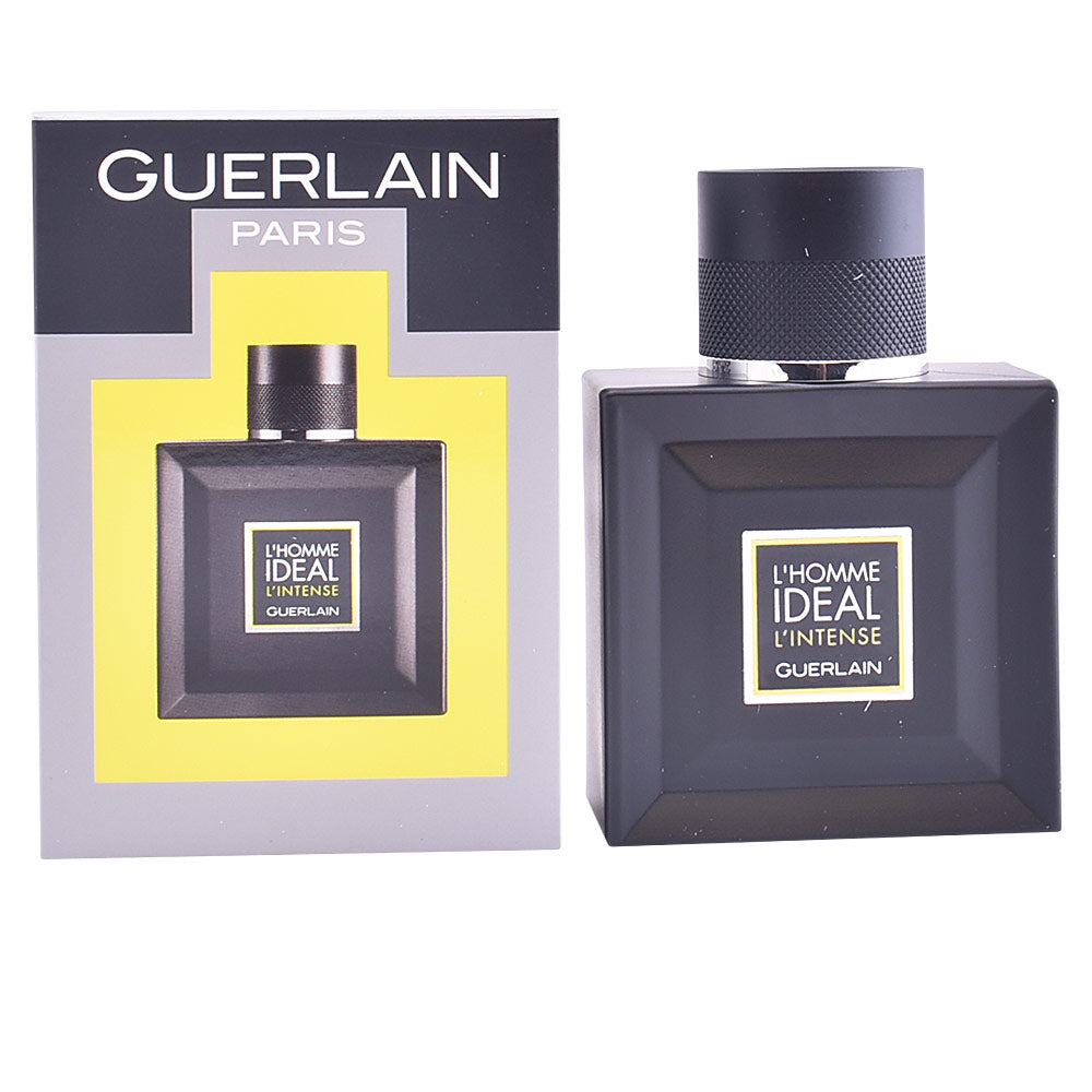 Clear square glass bottle with light amber liquid, black textured cap and simple front label, Guerlain.