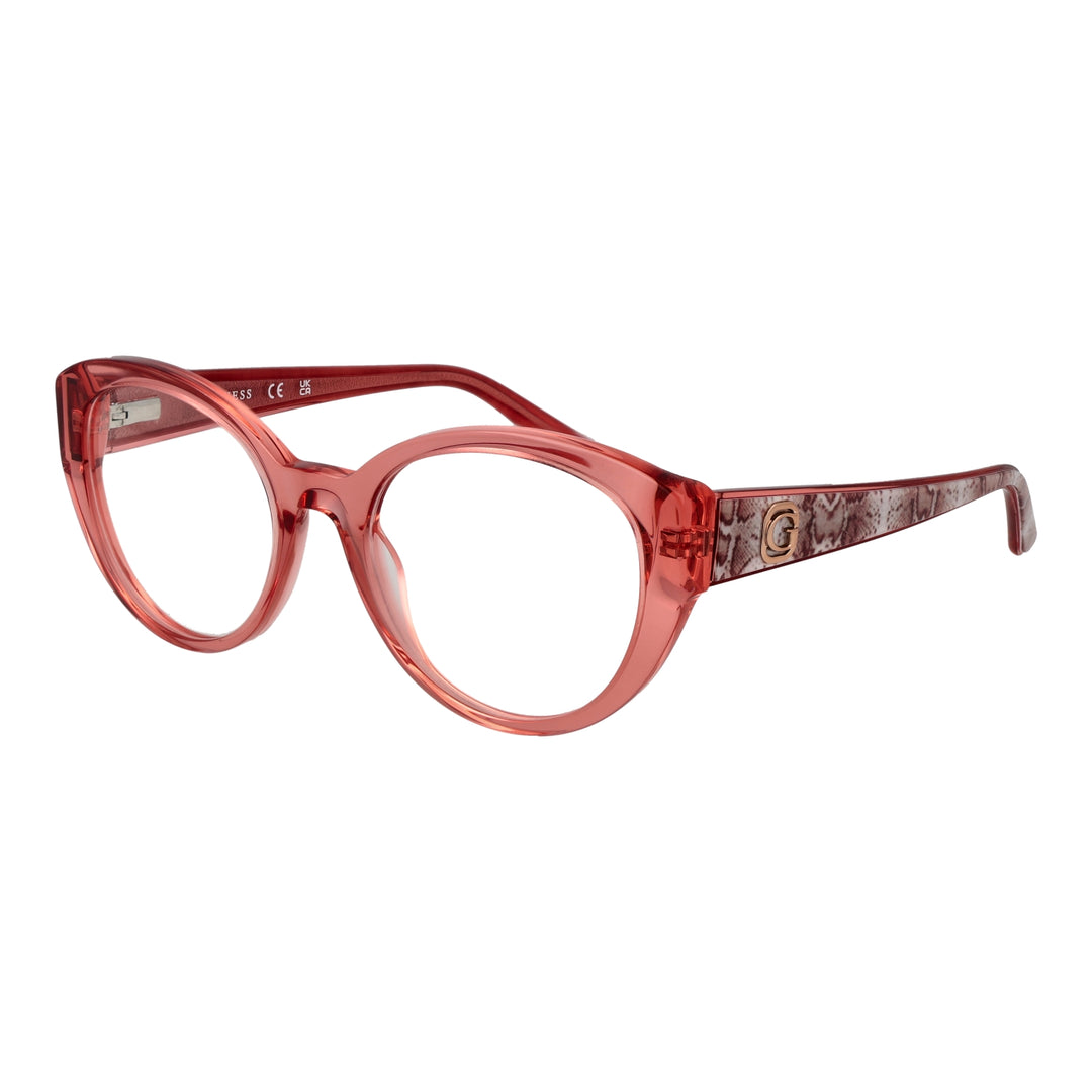 Transparent pink cat-eye eyeglasses with snake-skin patterned temples and small gold emblem