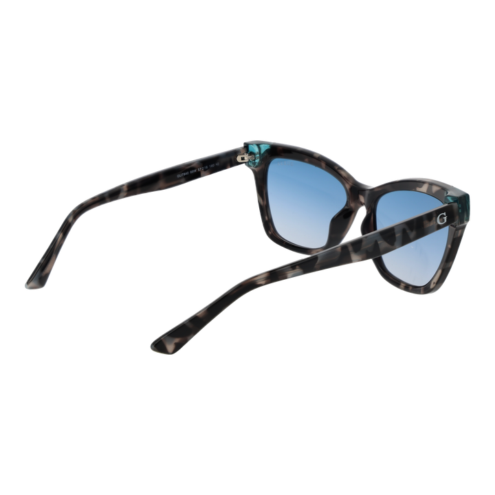 Guess tortoise cat-eye sunglasses with blue gradient lenses and teal corner accents on a neutral background