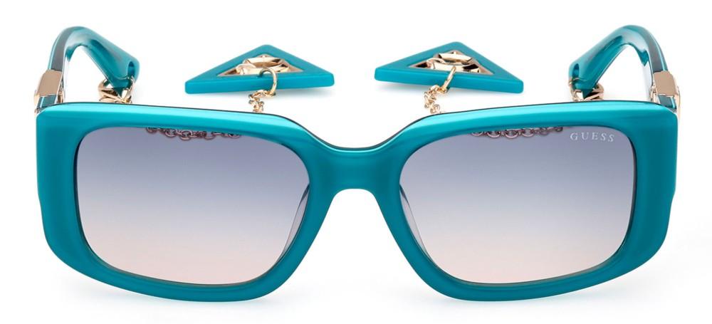 Teal rectangular sunglasses with gradient lenses, gold metal accents and dangling triangular charm chain on temples