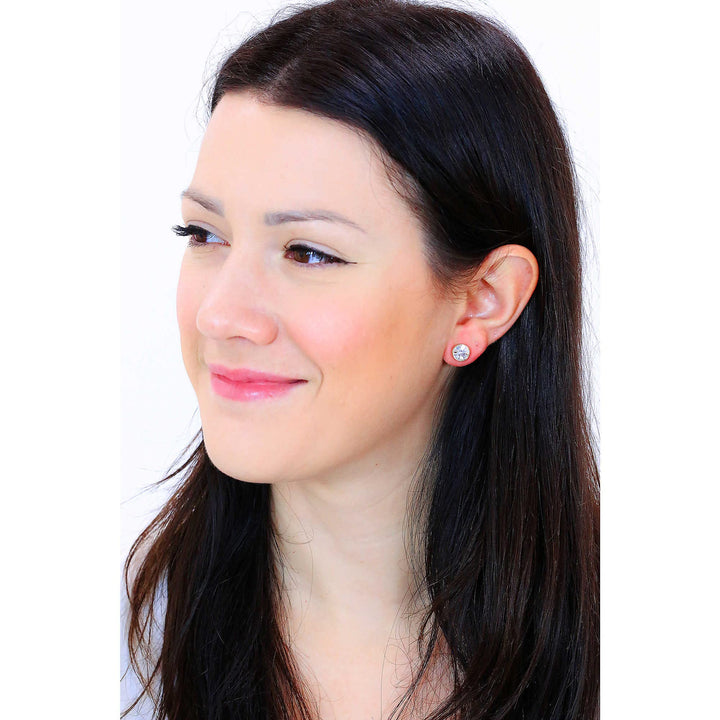 Pair of gold-tone stud earrings with round faceted clear crystals on white background, front view