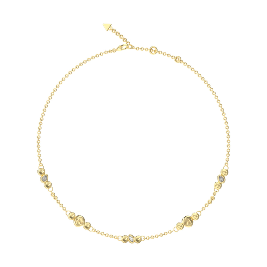 Delicate gold-tone chain necklace with small beads and arrow-shaped clasp end on white background