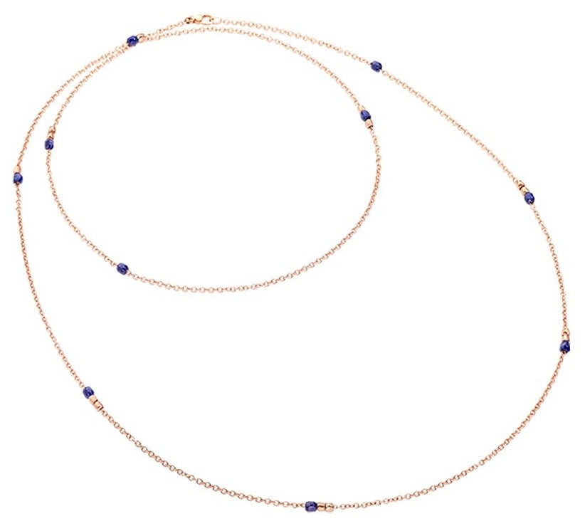 Delicate rose gold necklace with interspersed small blue gemstones on a neutral background