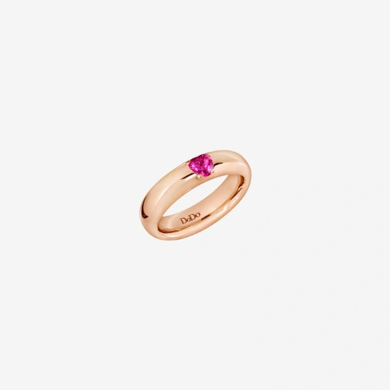 Rose gold ring for Women featuring a small pink gemstone set on a polished band, close-up studio image.