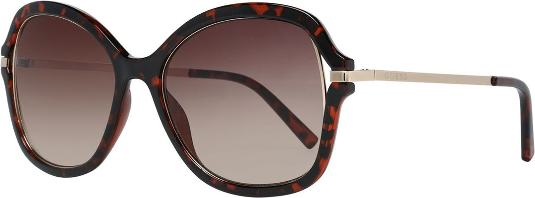 Oversized tortoise shell sunglasses with brown gradient lenses and slim metal temples on white background
